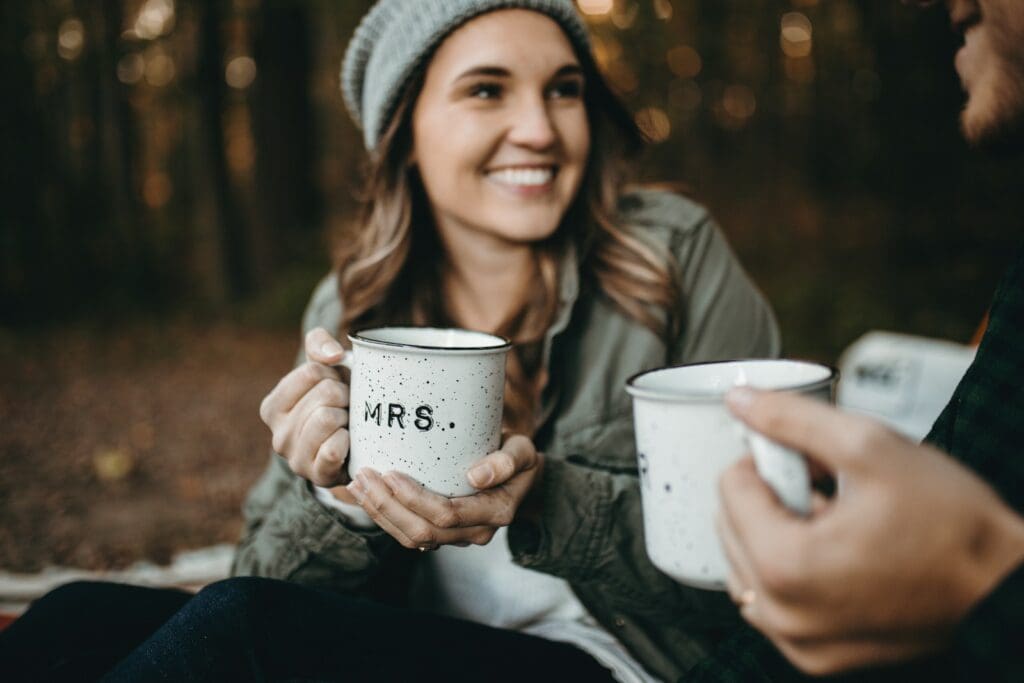 woman holding white mugs