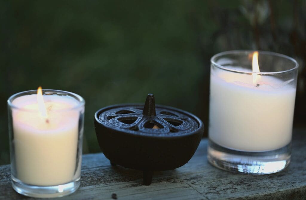 a couple of candles sitting on top of a wooden table