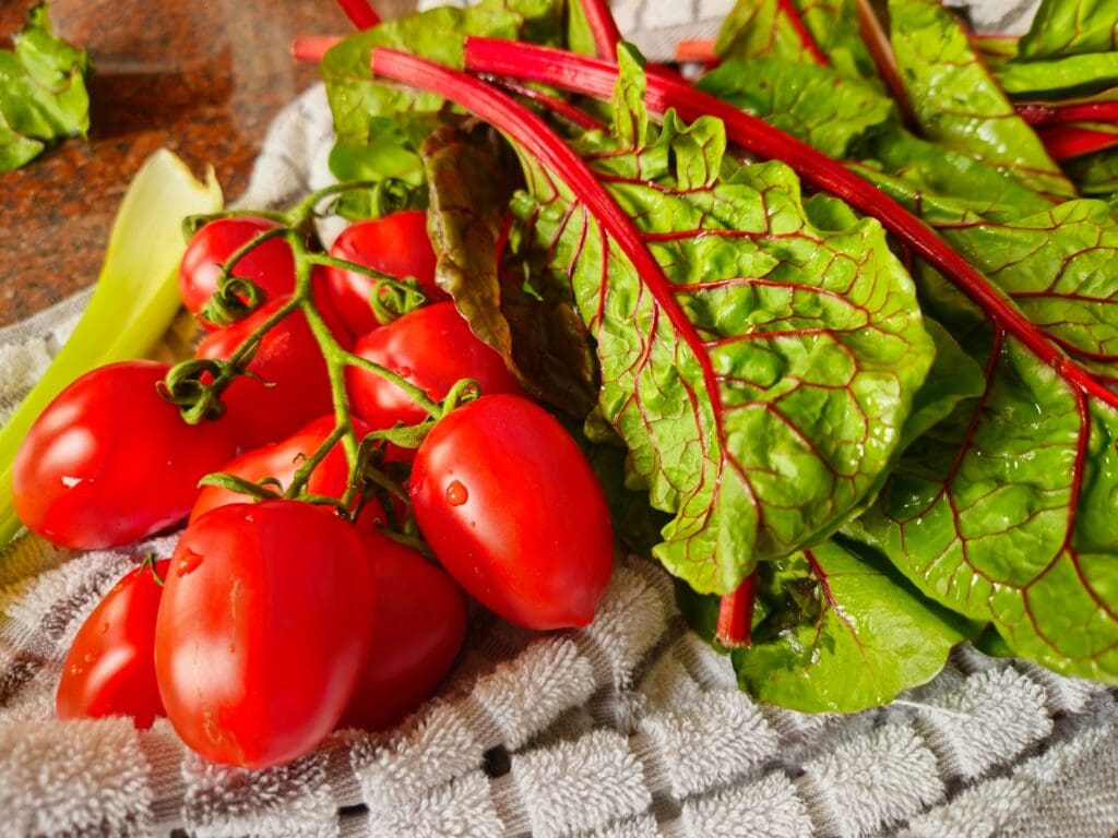 a pile of lettuce and tomatoes on a table