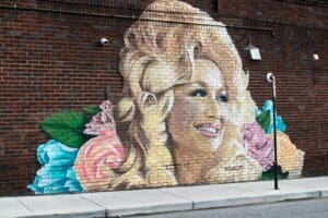 woman and girl painting on wall