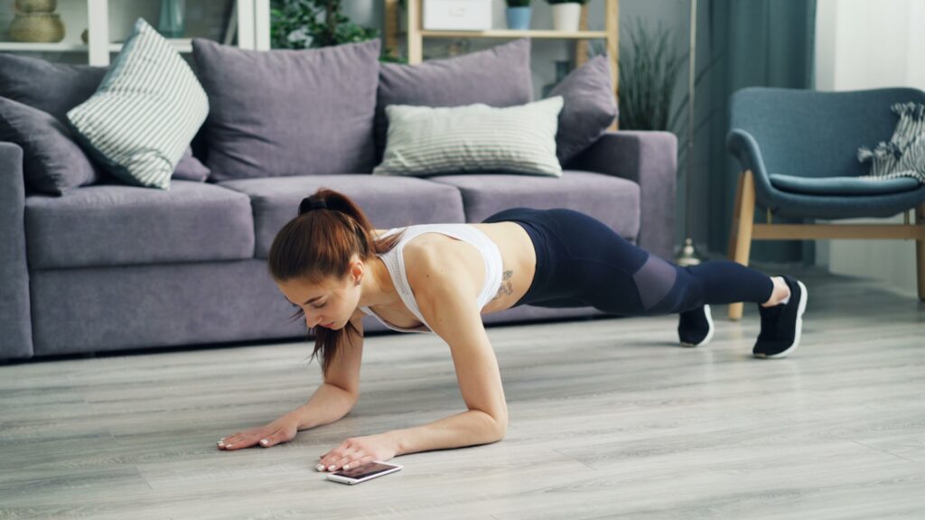 a woman is doing push ups on the floor