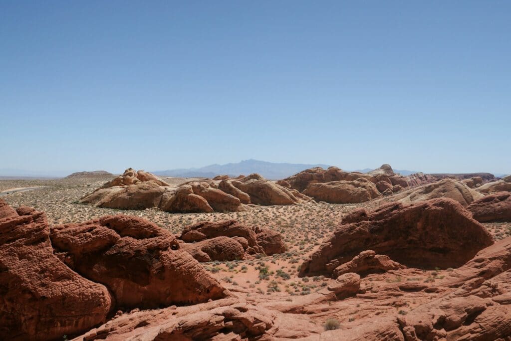 a desert landscape with rocks and mountains in the background