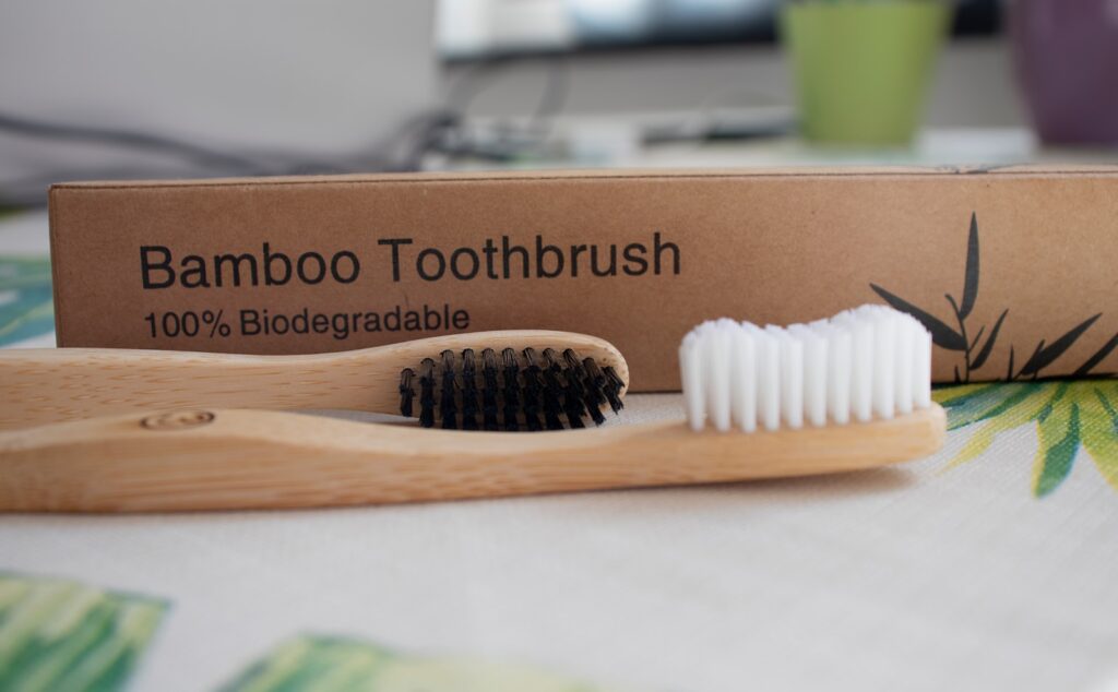 white plastic hair comb on brown wooden table