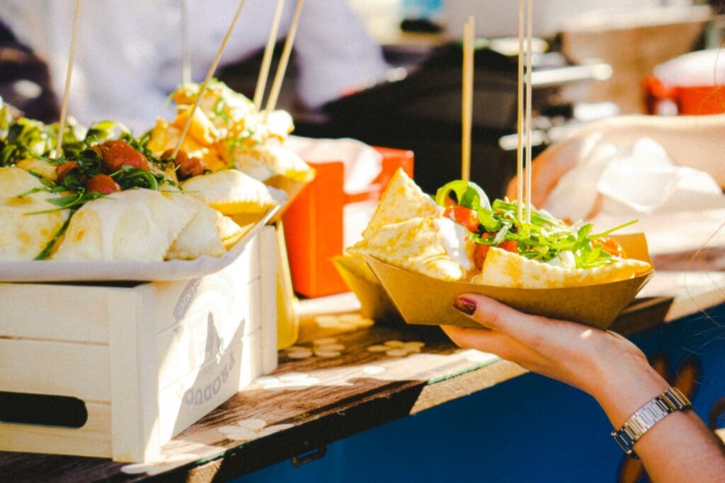 a woman is holding a bowl of food