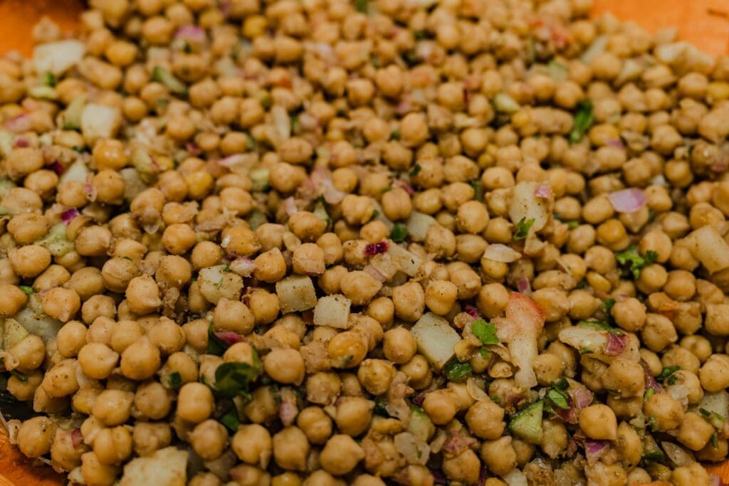 a plate full of chickpeas and onions on a table