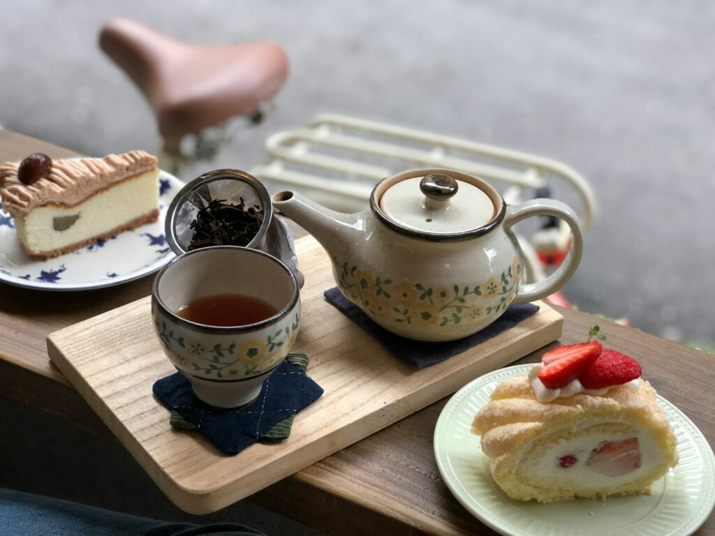 white and blue ceramic teapot on brown wooden tray