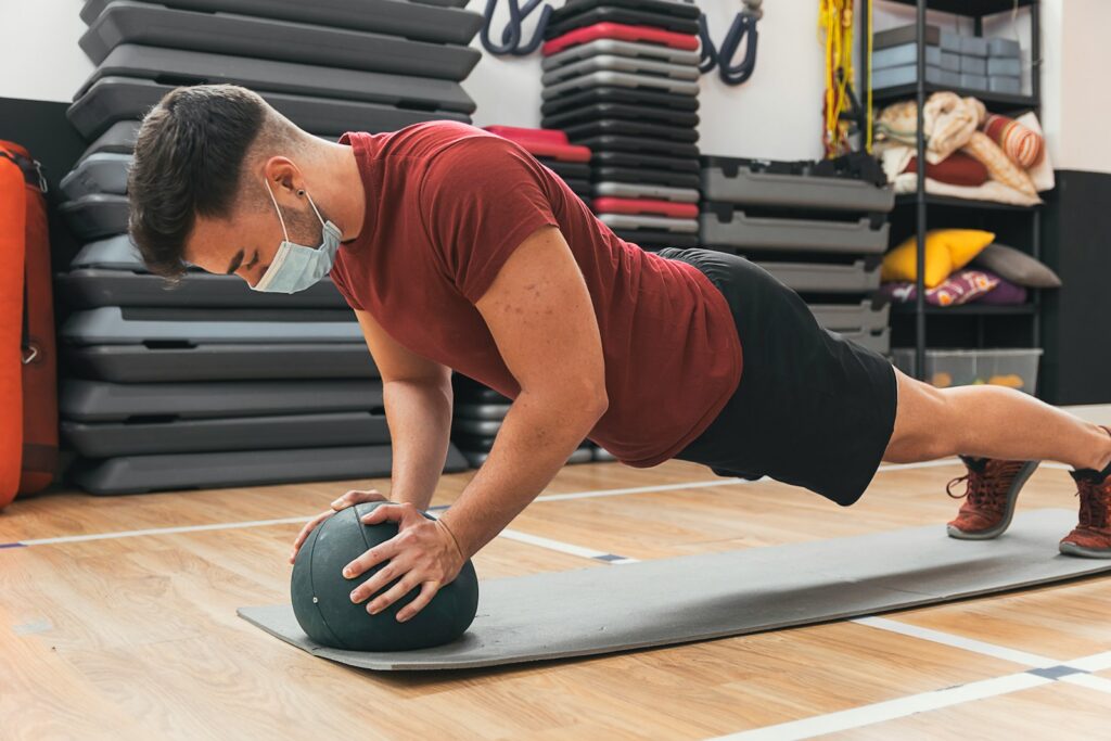 a man doing a plank on a gym floor