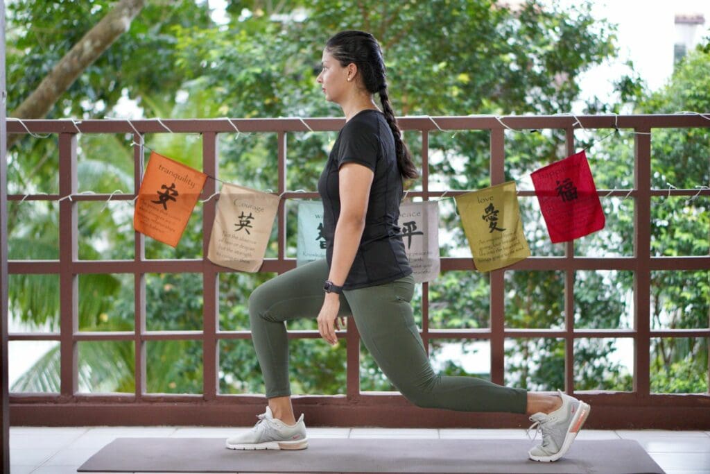 a woman in a black shirt is doing yoga