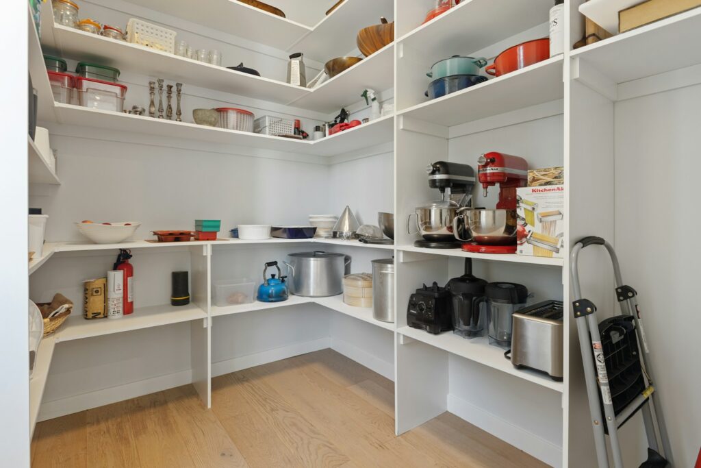 a white kitchen with white shelves