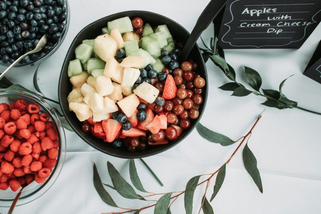 sliced fruits on black ceramic bowl