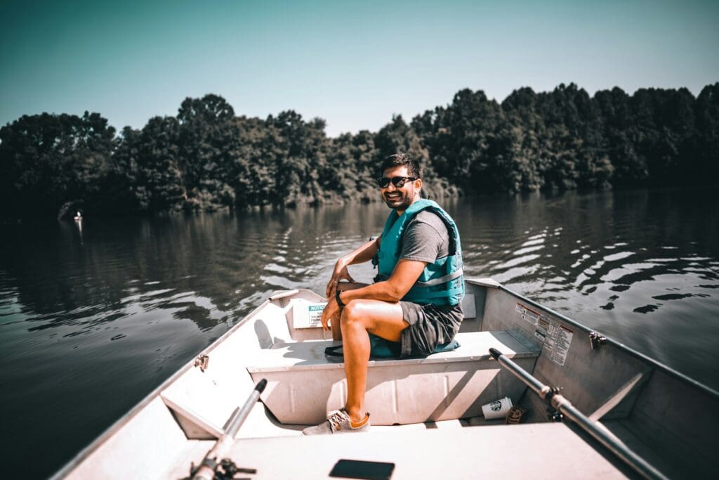 woman in blue shirt sitting on white boat during daytime