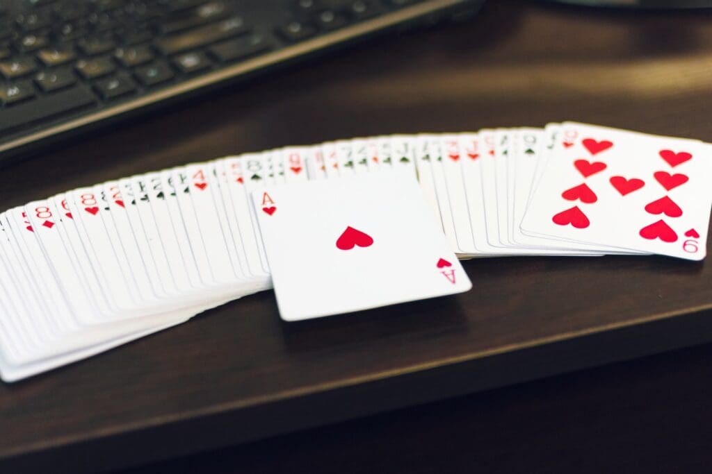 white and red playing cards on white paper