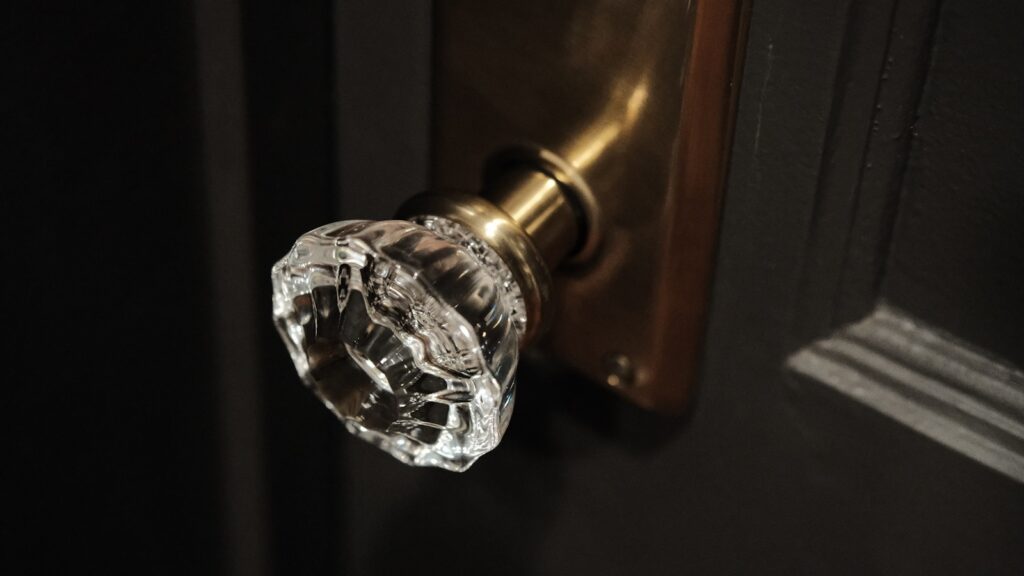 clear glass doorknob on brown wooden table