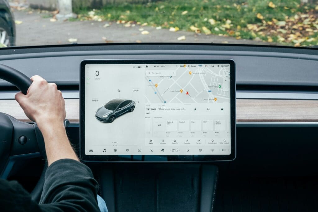 Person driving with computer on dashboard