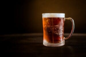 brown liquid on clear glass mug