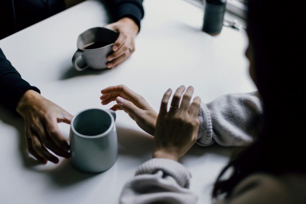 a group of people sitting around a white table