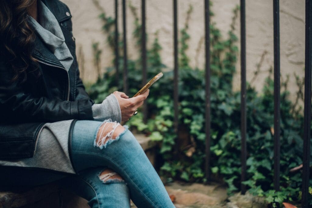 woman using gold smartphone