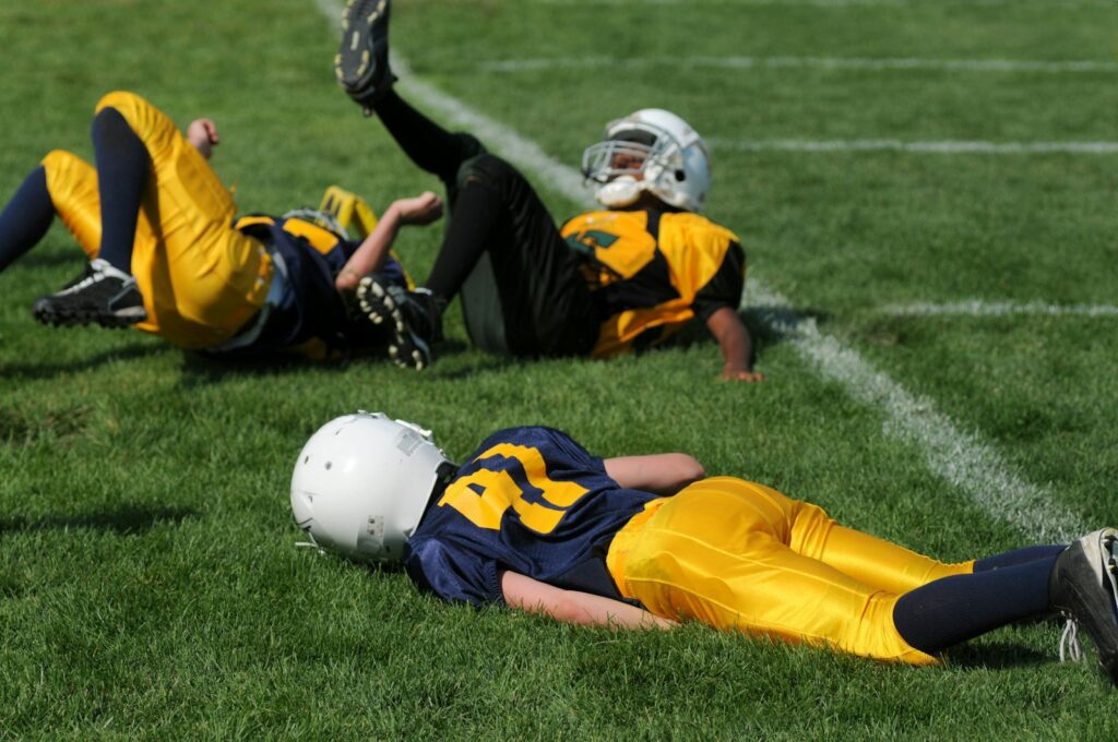 Football player lying on field