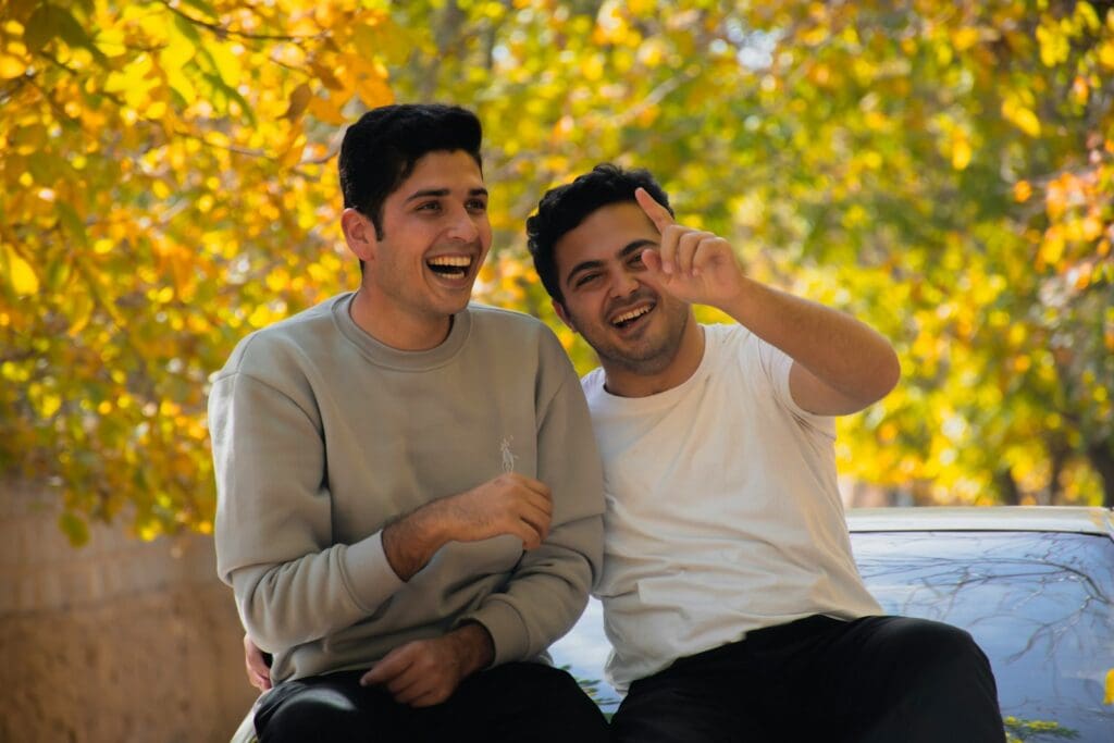 a couple of men sitting next to each other