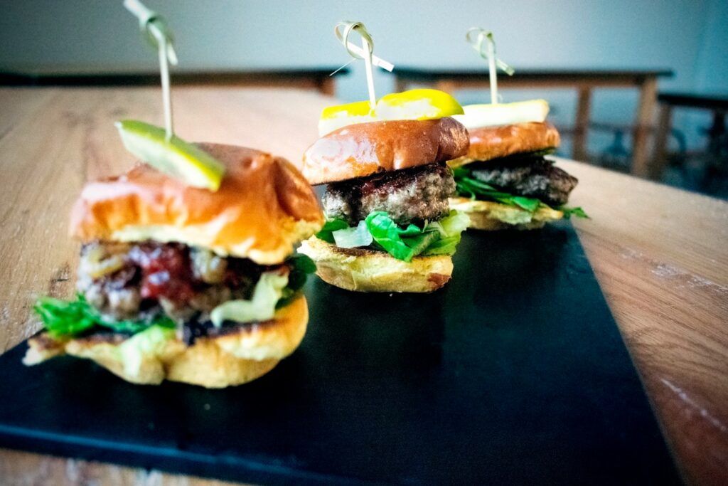 a couple of sandwiches sitting on top of a wooden table