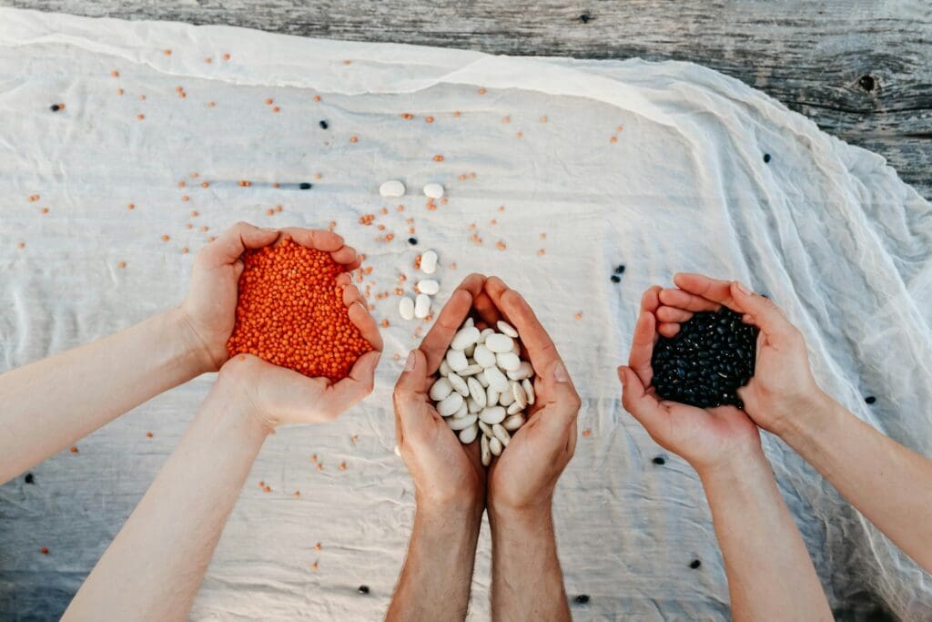 a group of people holding their hands over a bag of beans