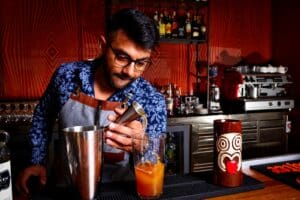 a man mixing a drink in a blender