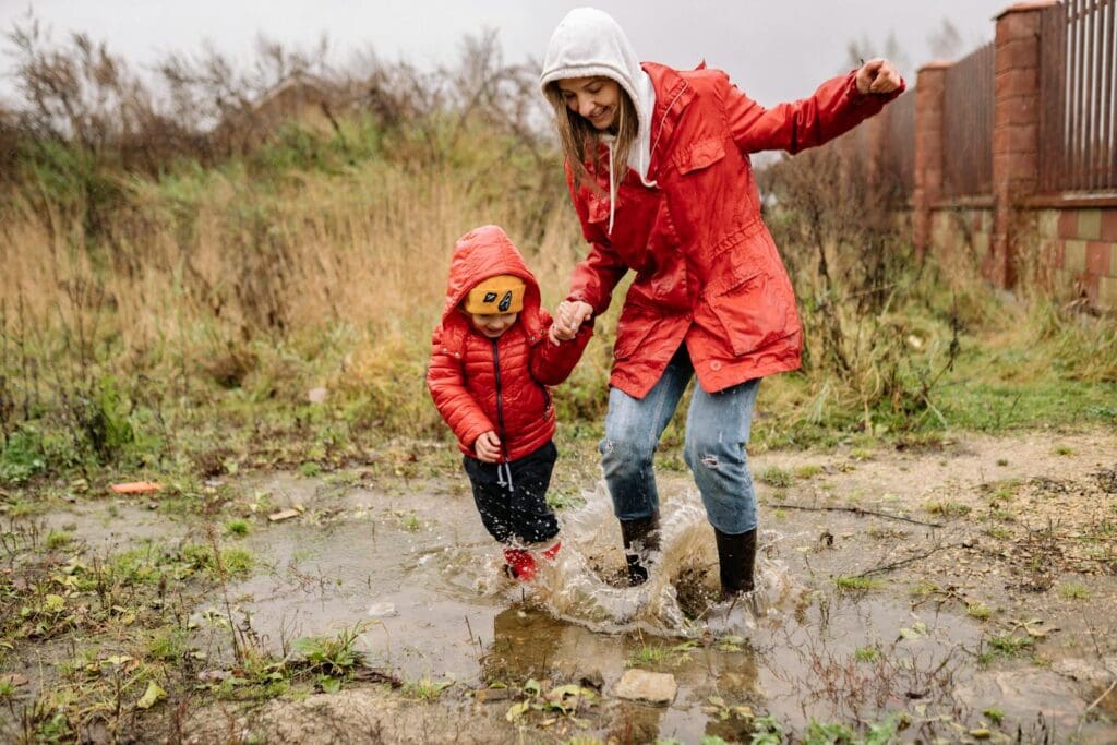 A Woman Playing on the Rain with Her Child