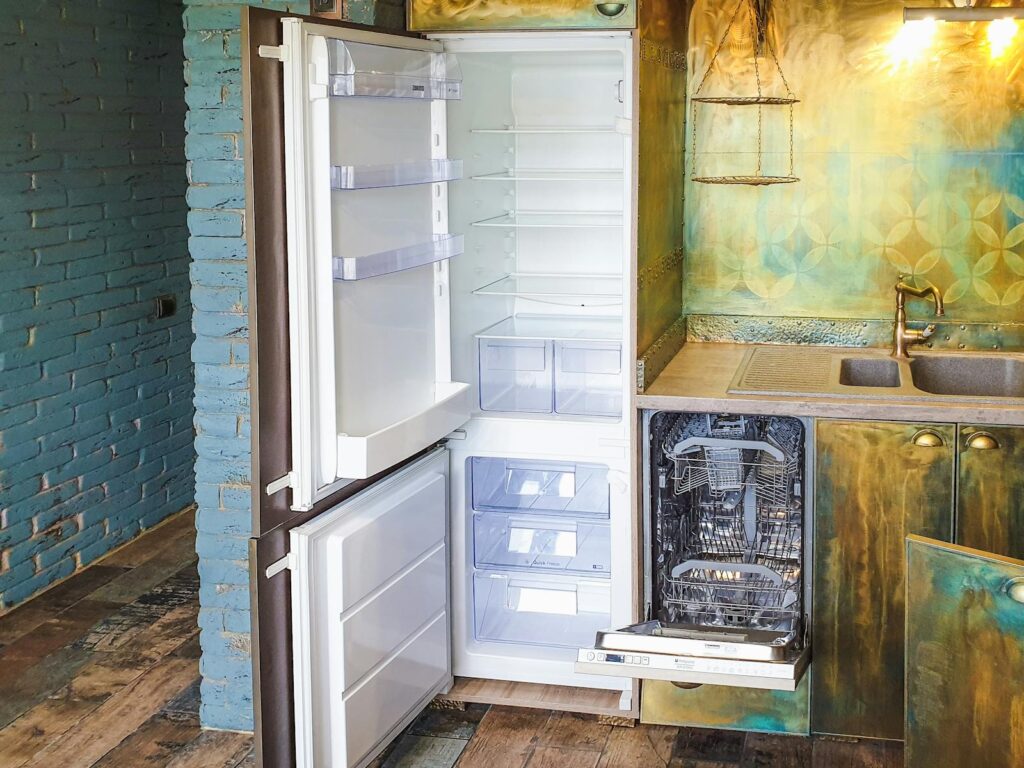 Stylish kitchen interior featuring an open refrigerator and dishwasher, showcasing contemporary design.