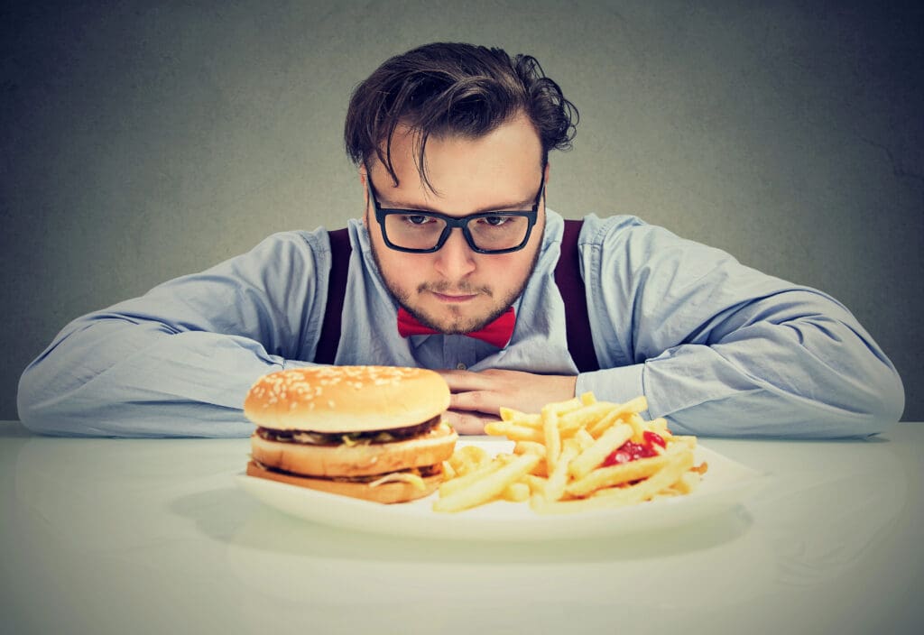 Man anxious about unhealthy fast food