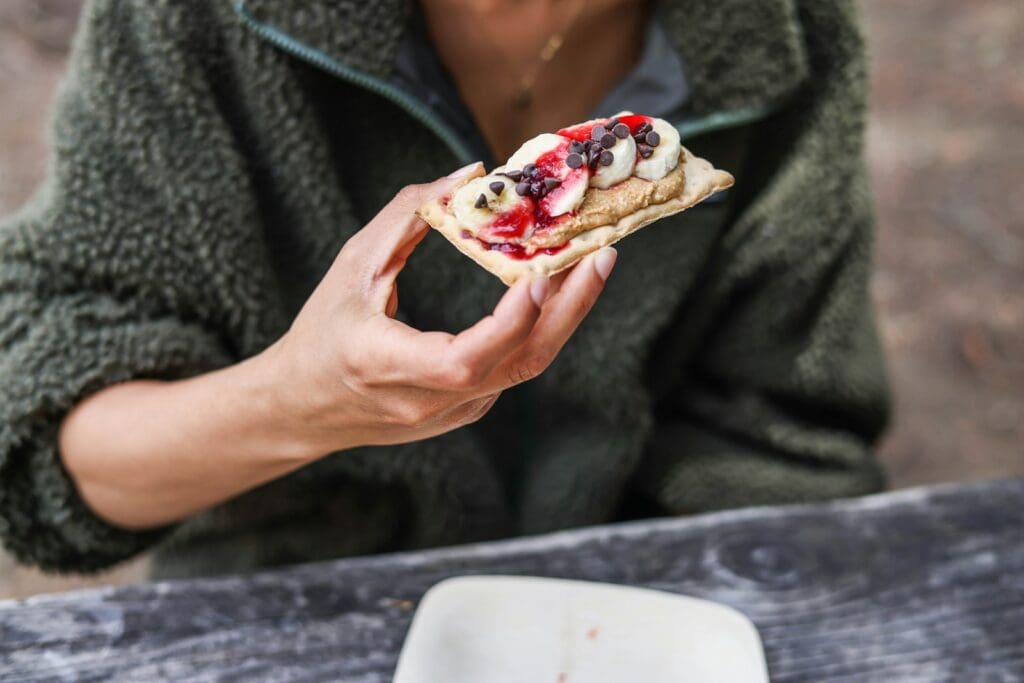 a person holding a piece of food