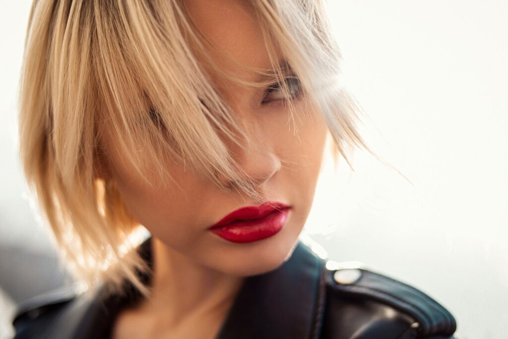 woman in black leather jacket and red lipstick