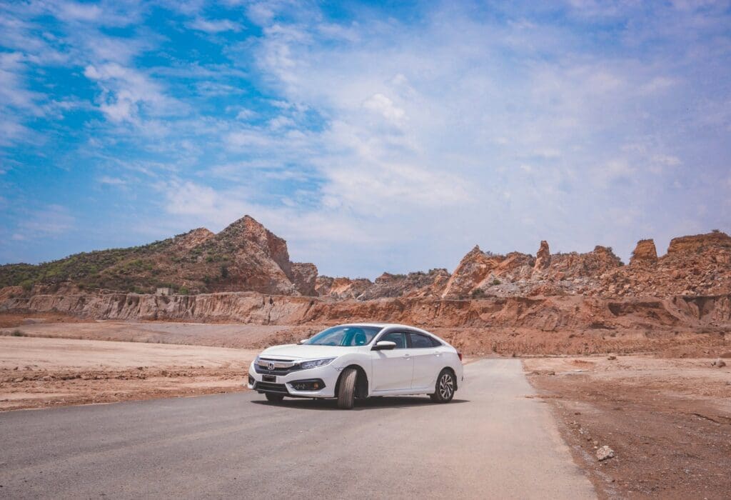 a white car parked on the side of a road