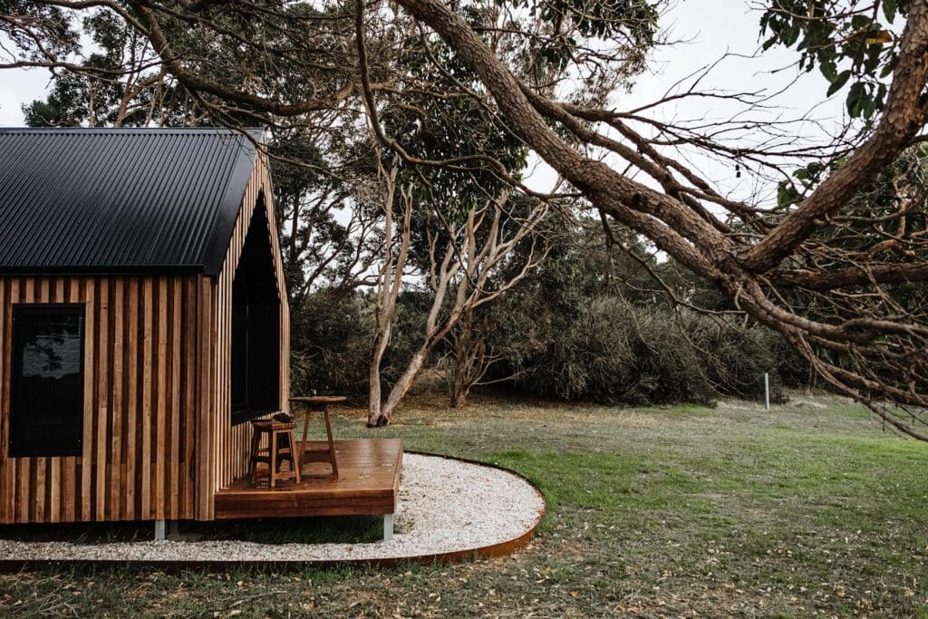 A stylish wooden cabin amidst lush greenery, ideal for a nature escape.