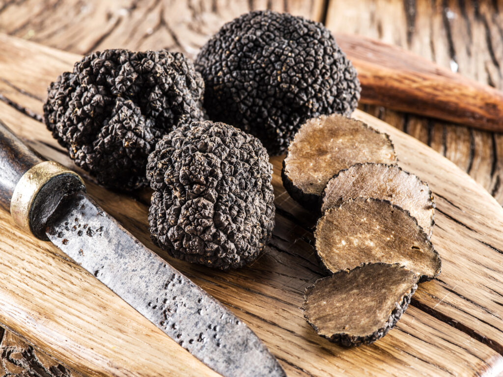 Black truffles on the old wooden table.