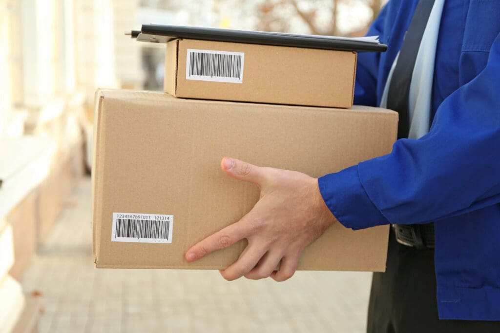 Courier with parcels on doorstep