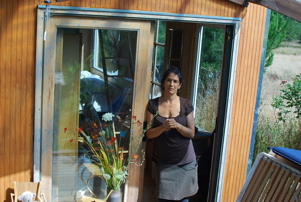 lulu, in the entrance of 1 of the 2 tiny houses she and her doughter inhabit
