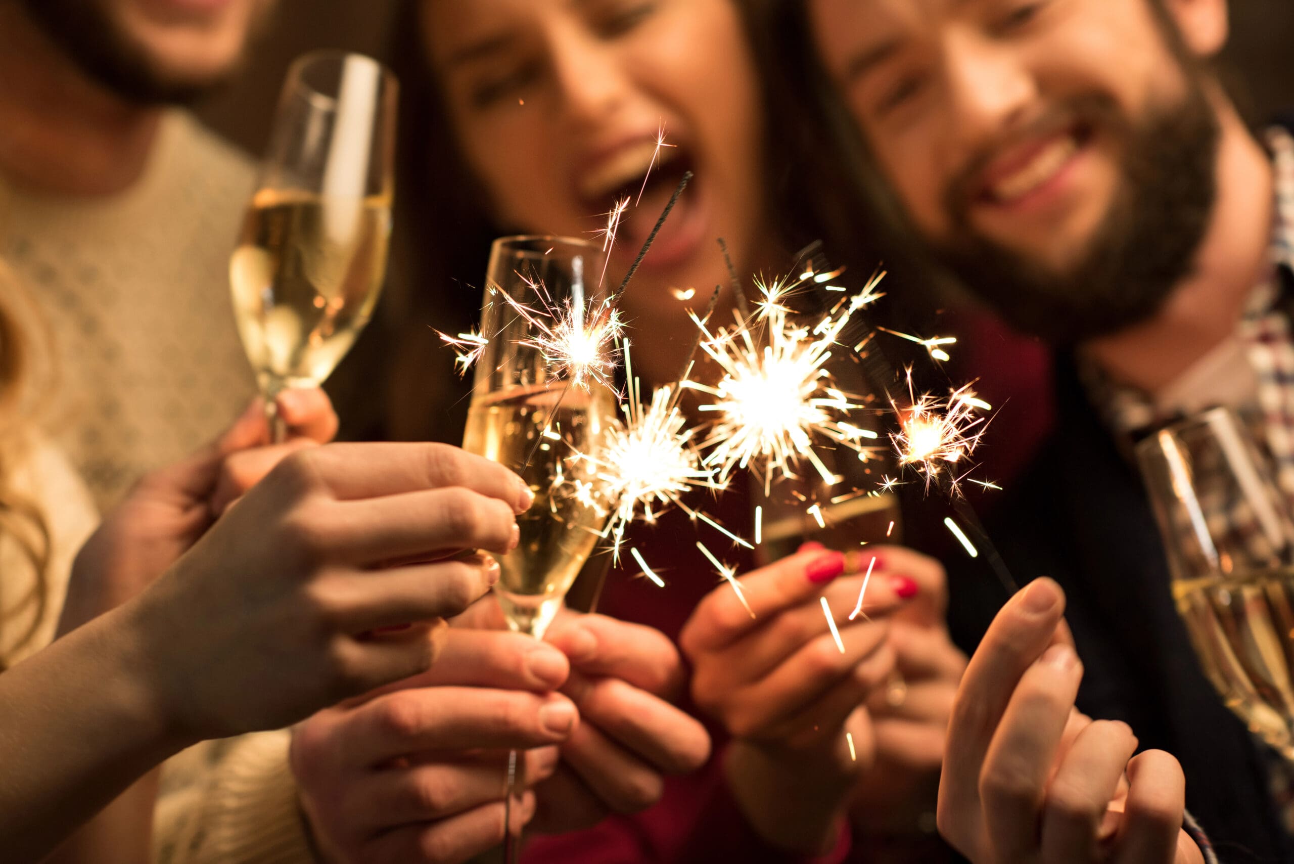 People with glasses of champagne and sparklers