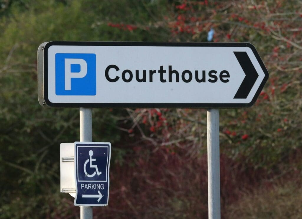 blue and white courthouse parking sign