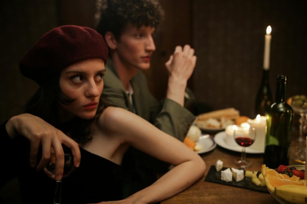 A romantic candlelit dinner with a couple enjoying a cozy evening. Parisian vibes and intimate setting.