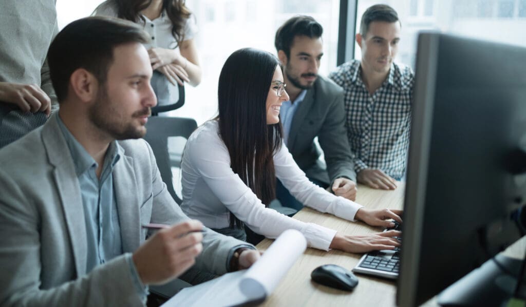 Software engineers working in office on project together