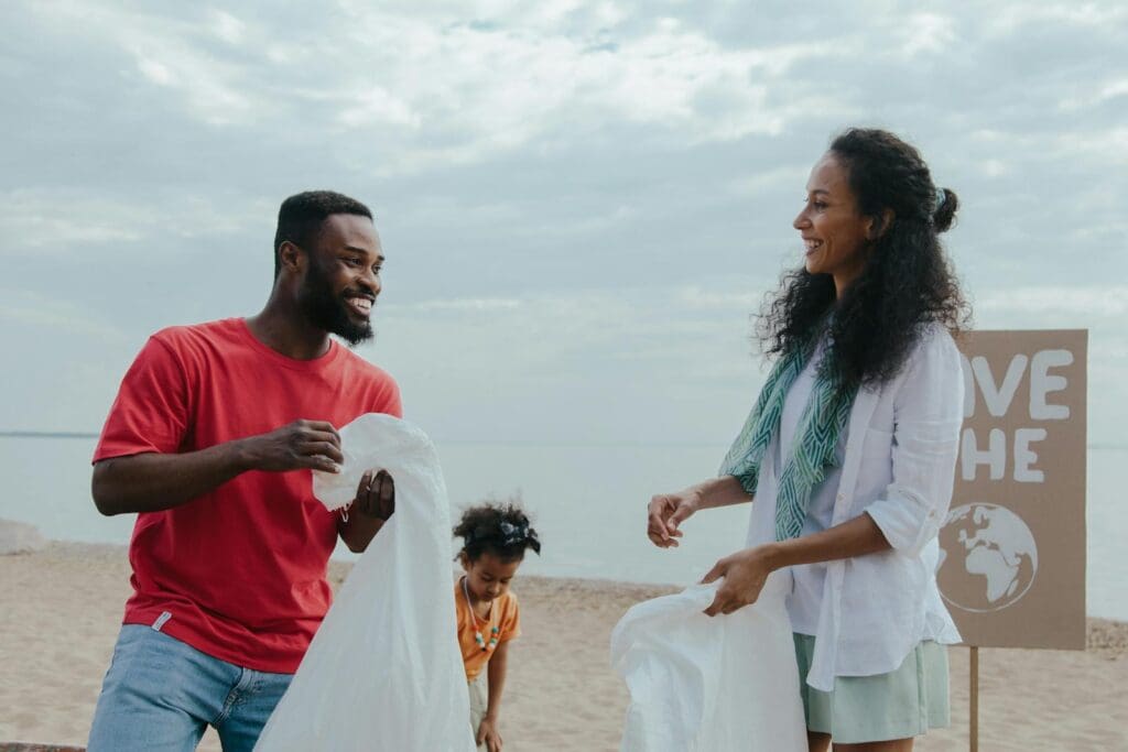 A family volunteering for a beach cleanup, promoting environmental awareness and sustainability.