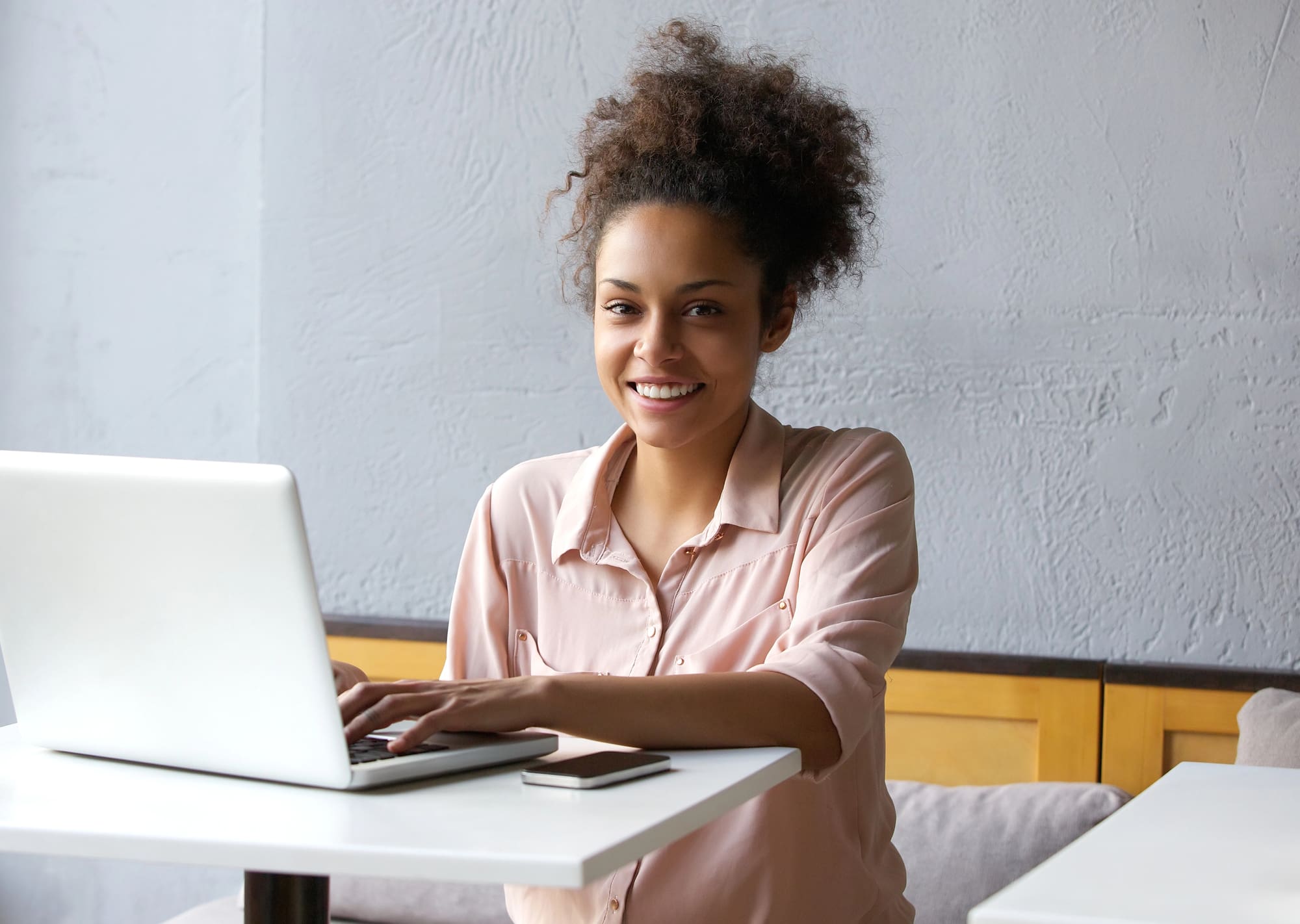 Smiling woman using a laptop