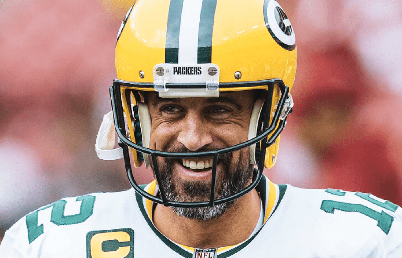 Aaron Rodgers playing football with smiling
