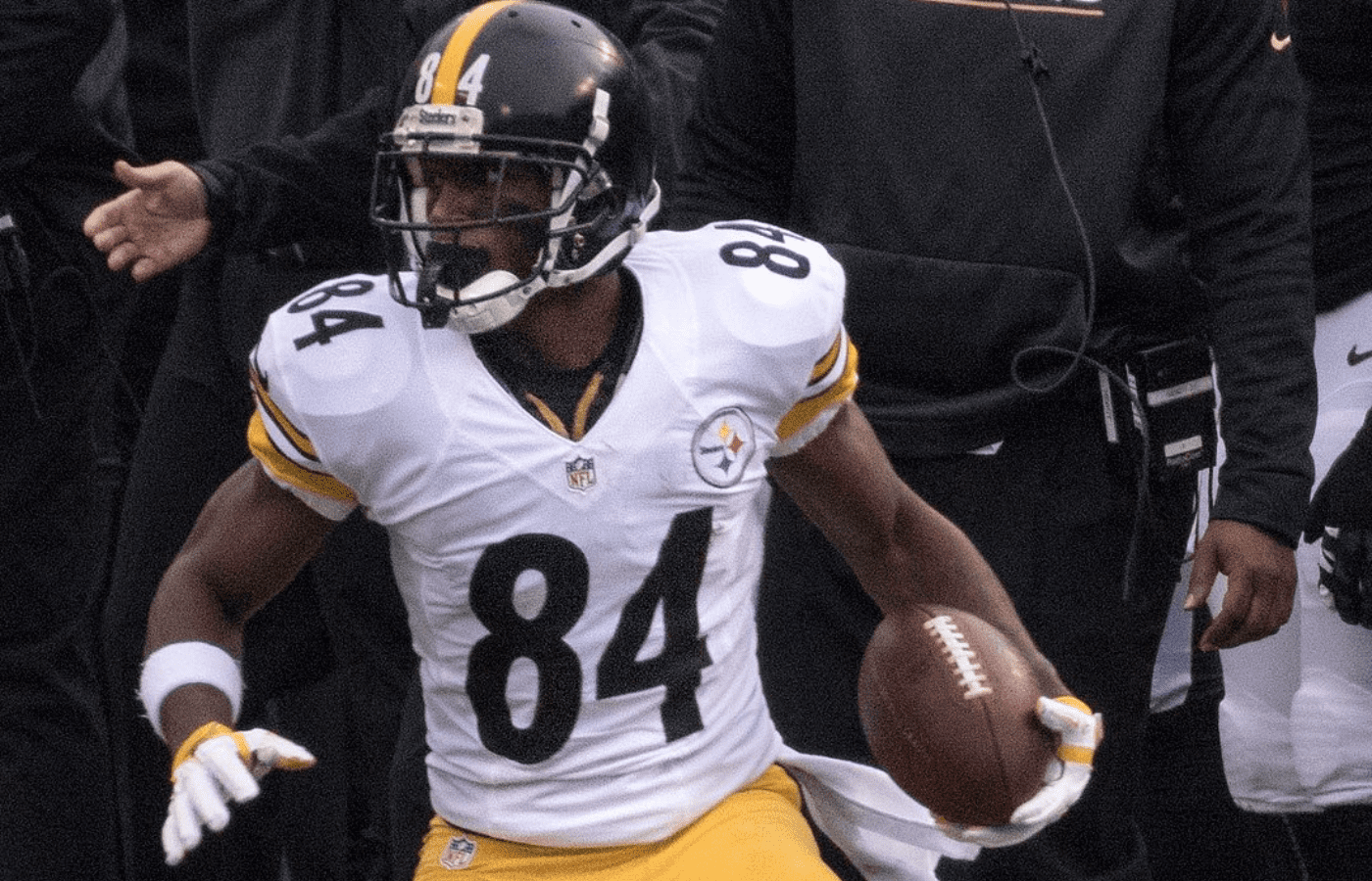 Antonio Brown is playing while wearing a white jersey and a helmet