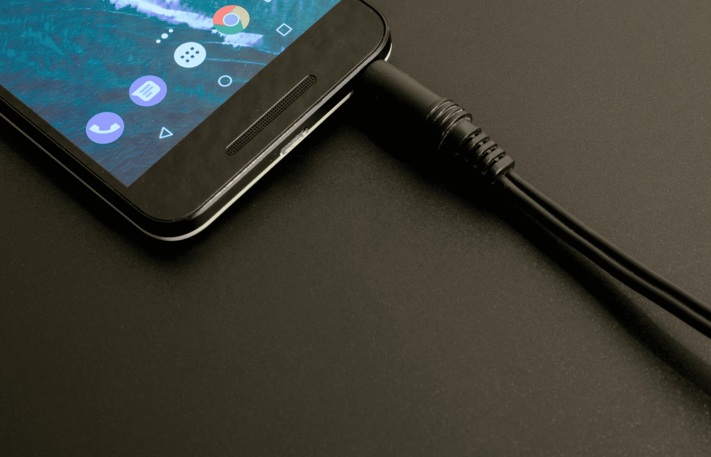 Smartphone connected to a charging cable