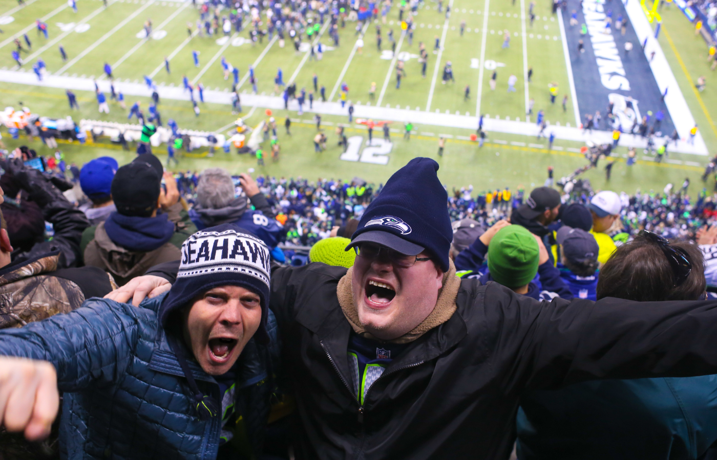 Excited Seattle Seahawks fans cheering at game