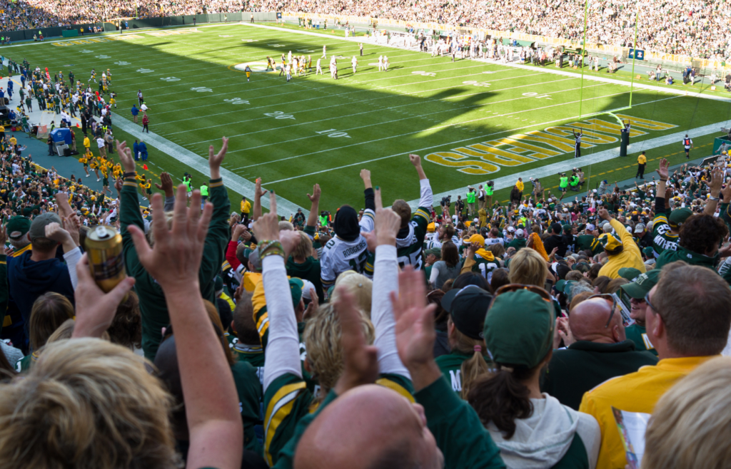 Excited football fans cheering at the game