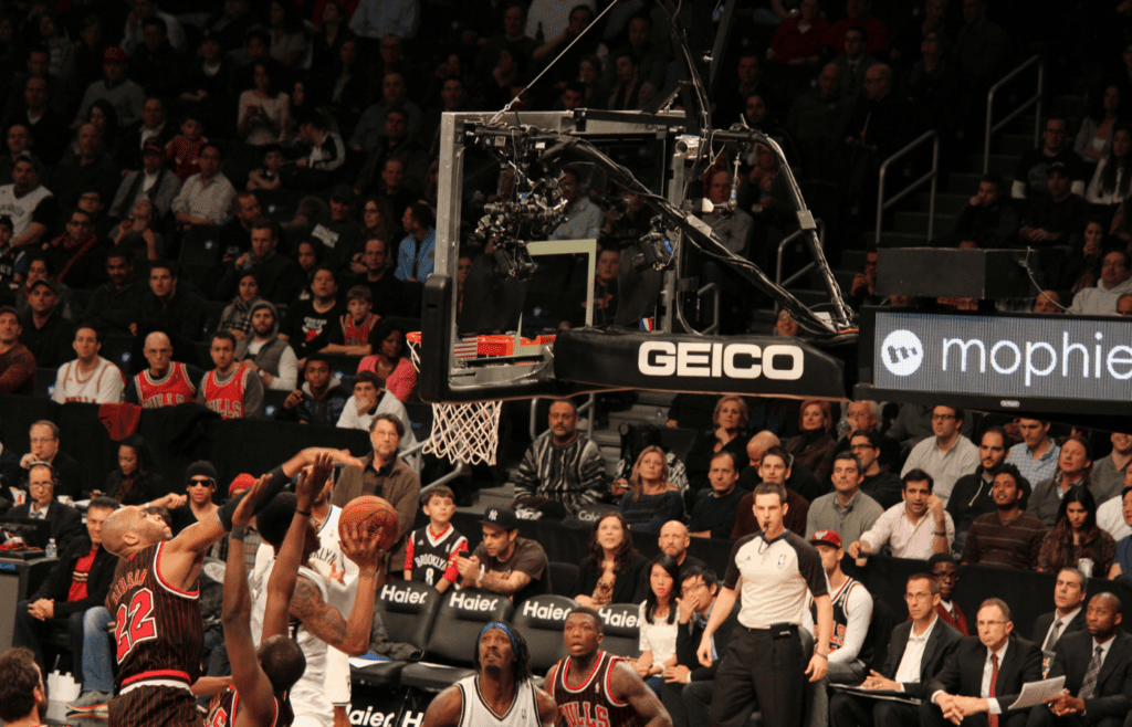 Brooklyn Nets fans intently watching action near basket