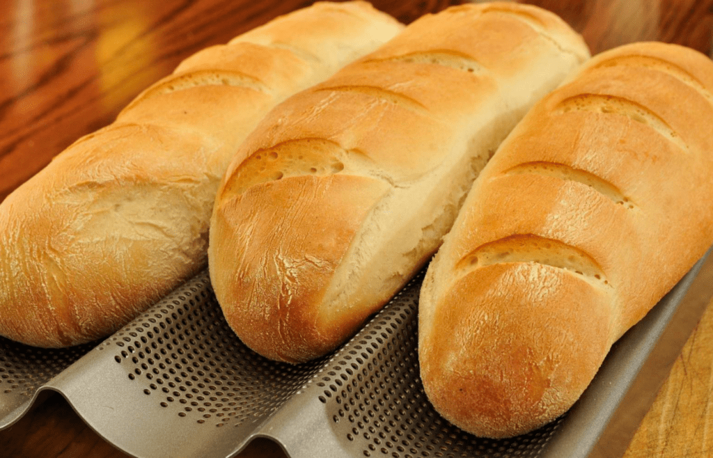 Three freshly baked loaves of french bread