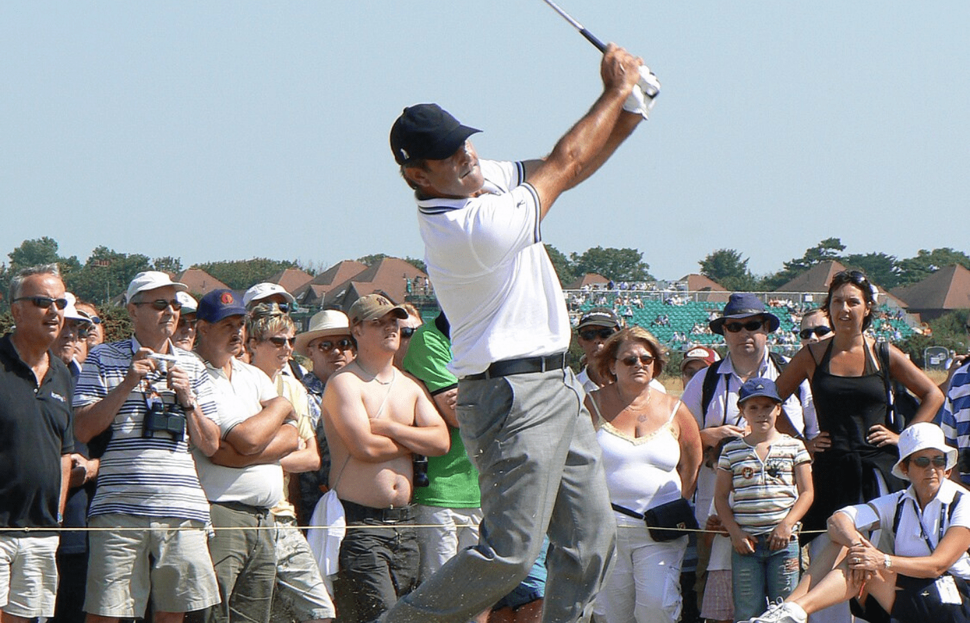 Seve Ballesteros swings, people watch intently
